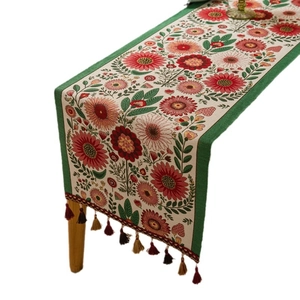 Floral jacquard table runner with sunflower patterns and colorful tassels on white