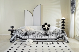 Detailed close-up of chenille sofa cover with monochrome plant patterns and tassel edges