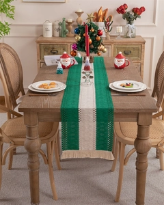 Detail of hand-woven striped table runner with tassels and hollow knit texture on wood