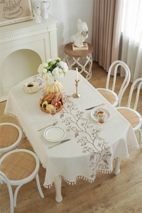 Detailed cream tablecloth with brown leaf embroidery and elegant handcrafted tassels