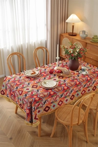 Detail of bohemian jacquard tablecloth with geometric patterns and gold tassel fringe
