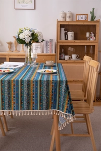 Detail view of Bohemian striped tablecloth with colorful geometric patterns and tassels