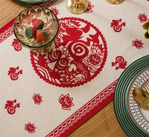 Detail of red jacquard Fu character and lotus pattern on beige textured fabric table runner