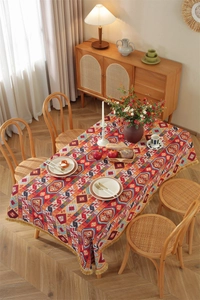 Close-up of bohemian geometric tapestry tablecloth featuring decorative yellow fringe detail