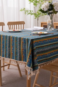 Macro detail of Bohemian striped tablecloth with gold foil accents and fringe