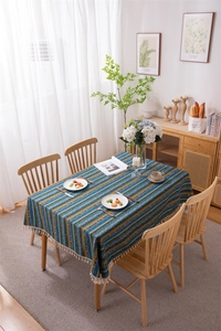Close-up of bohemian striped tablecloth with intricate patterns and handmade tassels