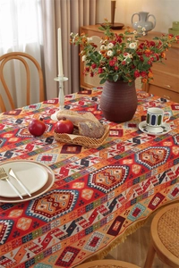 Close-up of bohemian jacquard tablecloth featuring geometric patterns and yellow tassels
