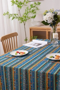 Close-up of bohemian striped tablecloth with ethnic geometric patterns on wood table