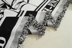 Macro shot of Nordic chenille sofa cover showing woven plant patterns and tassel fringe