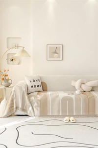 Detail of Nordic chenille sofa throw with geometric arch patterns and fine fringe edges