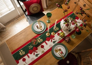 Detail of red festive Chinese New Year table runner with gold Fu character and tassels