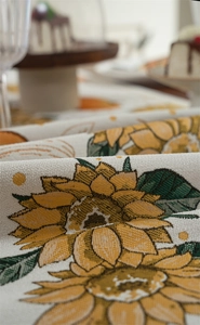 Macro shot of jacquard table runner featuring yellow sunflowers and woven texture