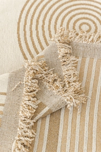 Detail of Nordic chenille sofa throw with geometric patterns and handmade tassels