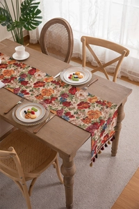 Detail of vintage American style table runner with floral jacquard and colorful tassels