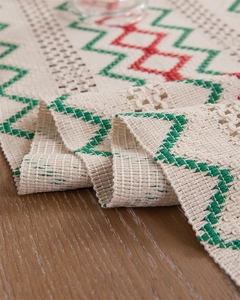 Detail of woven table runner showing geometric knit pattern and textured cotton tassels