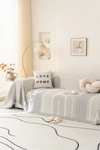 Detail of Nordic chenille throw blanket with abstract grey arches and fringed edges
