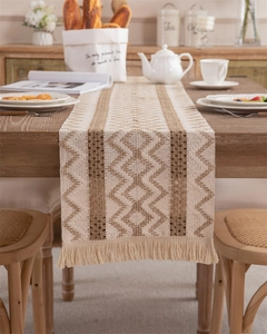 Macro shot of boho woven table runner featuring tassel fringe and wavy geometric textures