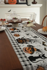 Detail of Halloween table runner featuring black cats, pumpkins and spooky castles