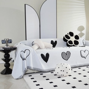 Nordic chenille sofa cover with black heart jacquard patterns and gray fringe tassels