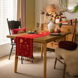 Chinese New Year red table runner with gold jacquard patterns and festive tassels