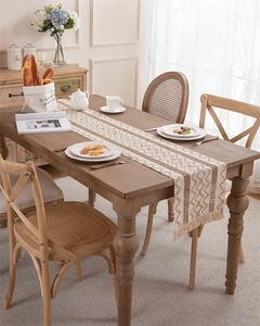 Close-up of bohemian woven table runner with geometric waves and fringe tassels