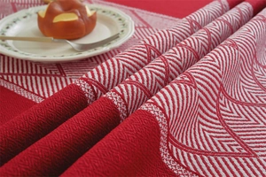 Macro shot of red and white jacquard tassel tablecloth with woven herringbone texture