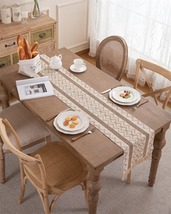 Close-up of geometric wave patterns and fringe detail on the woven cotton linen table runner