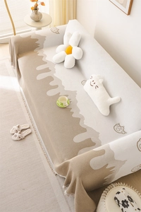 Detail of Nordic chenille sofa cover with wavy pattern, cartoon bears, and fringe trim