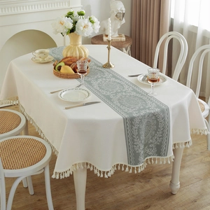 Beige table cloth with retro green floral pattern and elegant tassel edges