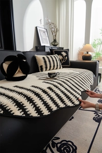 Detail of black and white geometric jacquard sofa cover with thick textured plush fabric