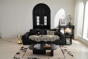 Detail of jacquard wavy edge sofa cover and floral rug in modern minimalist interior