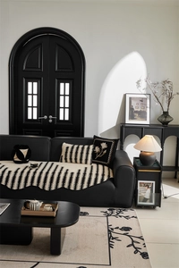 Detailed knit texture of black and white wave pattern sofa cover with scalloped edges