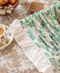 Detailed view of pastoral cotton fabric curtain with green leaves and white ruffles
