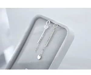 Detailed close-up of S925 sterling silver tassel earrings with round disk and long chain