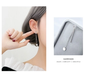 Detail of S925 sterling silver drop earrings with asymmetrical disc and long chain