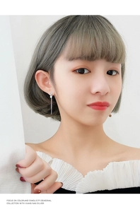 Close-up of elegant S925 sterling silver long chain earrings worn by a model