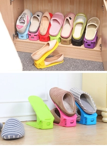 Macro detail of adjustable double-layer plastic shoe slots in multiple colors for storage