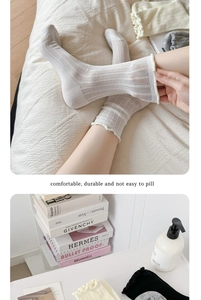 Detailed view of women's breathable mesh mid-calf socks featuring delicate ruffle edges