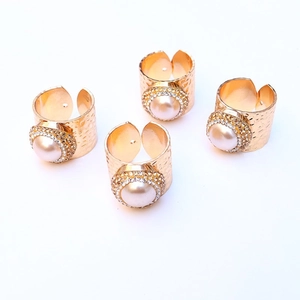 Set of 4 elegant gold napkin rings with hammered texture, pearls and sparkling rhinestones