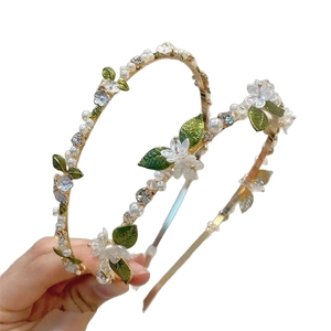 Elegant floral headband with gold metal frame pearls and green leaves for women