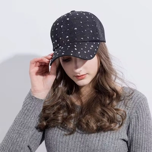 Detailed close-up of sparkling rhinestones on a stylish black cotton baseball cap for women