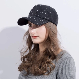 Detail of a black baseball cap for women featuring sparkling rhinestones and silver studs
