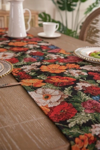 Close-up of vintage floral jacquard table runner with fringe and detailed texture