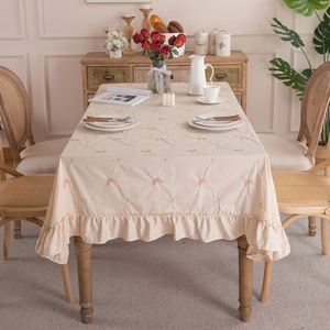 Elegant cream cotton tablecloth with orange butterfly embroidery and ruffled skirt edge
