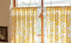 Detail of floral daisy print cotton curtain with ruffle edge for kitchen window decor