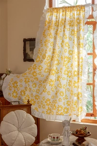 Detail of cotton short curtain with yellow daisy print and elegant white ruffled edge