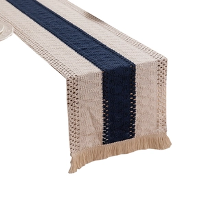 Handwoven boho table runner with navy blue stripes and decorative tassels for dining decor