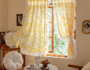 Detailed view of yellow cotton cafe curtain with white daisies and ruffled edges