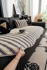 Detail view of the thick plush wavy stripe sofa cover showing anti-slip backing texture