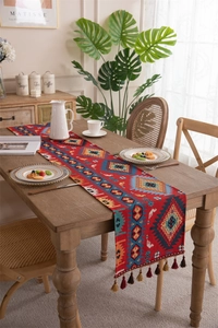 Detail of vintage bohemian table runner with jacquard patterns and elegant tassels